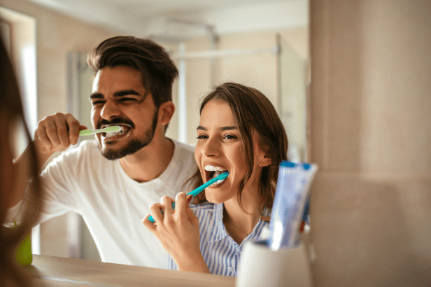 A Couple Brushes Their Teeth